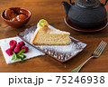 A slice of tender cheesecake with lemon 75246938