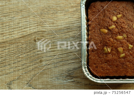 butter banana cake topping peanut in aluminum tray on table 75256547