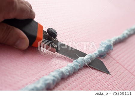 the master with a knife cuts off excess construction foam the master with a knife cuts off excess construction foam 75259111