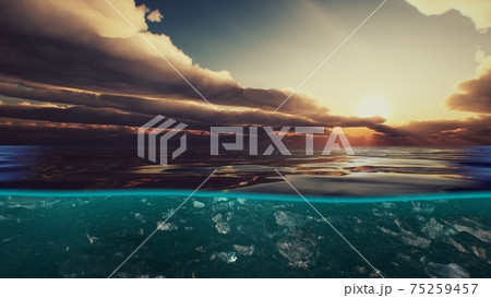 Split view over and under water in the Caribbean sea with clouds Split view over and under water in the Caribbean sea with clouds 75259457
