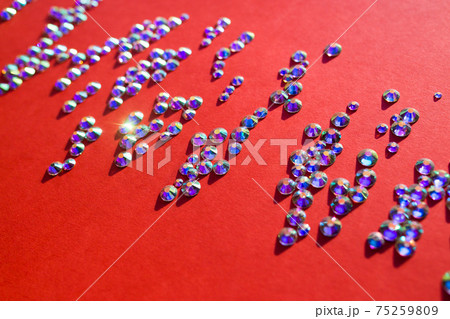 rhinestones on a red background, blure. design for text 75259809