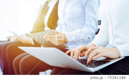 Group of diverse business people working in office, close-up. Woman working with laptop. Conference, meeting or training concepts 75261186