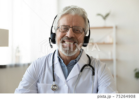 Headshot portrait of smiling senior doctor talk on video call 75264908