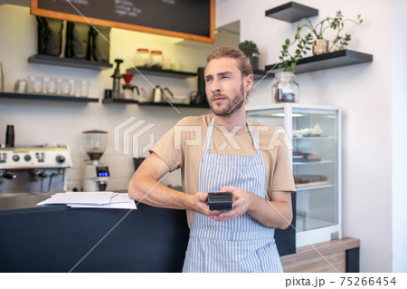 Thinking man with pos terminal in his hands 75266454