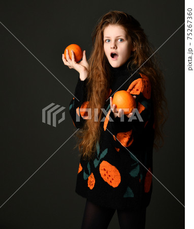 Teen girl with surprised facial expression and 75267360