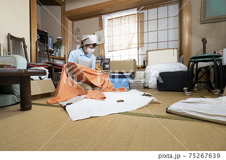 散らかった部屋を片付ける女性作業員 75267639