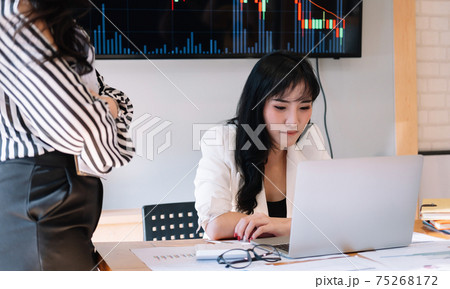 Business people meeting in office and discussing over a documents, two woman with a financial report with partner colleague on laptop computer Business people meeting in office and discussing over a documents, two woman with a financial report with partner colleague on laptop computer 75268172