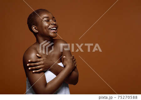 Chherful Beautiful Black Lady Standing With Folded Arms Wrapped In Towel Chherful Beautiful Black Lady Standing With Folded Arms Wrapped In Towel 75270588
