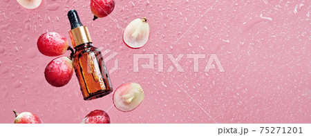 Organic cosmetics with grape seed oil and herbal ingredients. Zero Waste Winemaking. Skincare product bottle, grapes and water drops, banner format 75271201