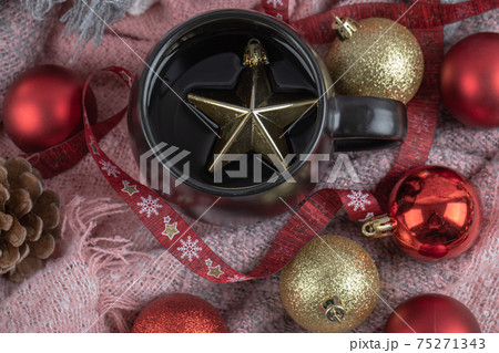 Red and golden christmas figures in the cup and around it Red and golden christmas figures in the cup and around it 75271343