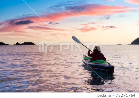 Adventurous Girl kayaking in the Pacific Ocean. 75271764