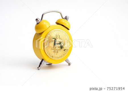 Yellow Alarm clock shows bitcoin on display. Good time to earn and mining a crypto currency 75271954