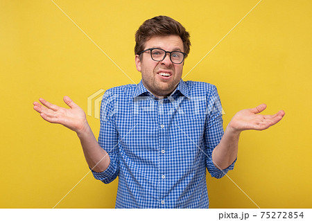 Confused clueless man shrugging shoulders, making no idea gesture, whatever. Confused clueless man shrugging shoulders, making no idea gesture, whatever. 75272854