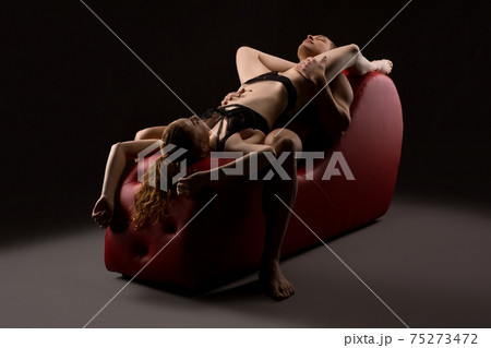 Passionate couple dream about sex on red leather chair 75273472