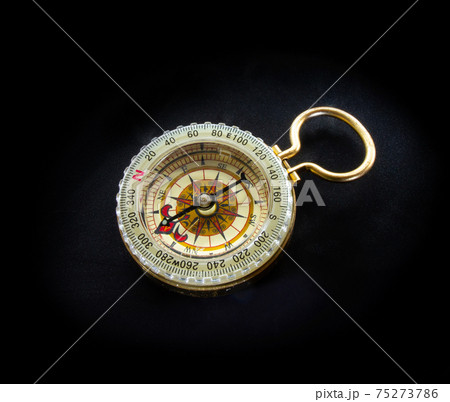 Old retro antique vintage beautiful navigation compass isolated on black background flat lay top view. Old retro antique vintage beautiful navigation compass isolated on black background flat lay top view. 75273786