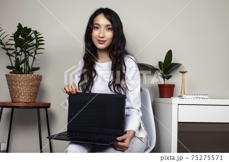 young pretty asian woman in white form working in clinic with laptop, lifestyle working people concept 75275571