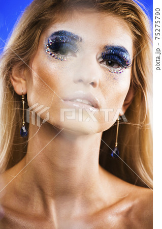 beauty young snow queen in fairy flashes with hair crown on her head close up in cold blue light beauty young snow queen in fairy flashes with hair crown on her head close up in cold blue light 75275790