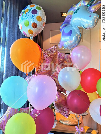 birthday balloons with inflatable unicorn in the room 75280168