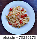 Creamy pasta with shrims and cherry tomatos on the white plate 75280173