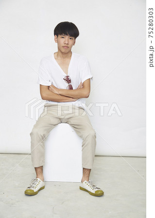 Handsome Asian guy on white 75280303