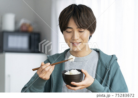 ごはんを食べる若い男性の写真素材