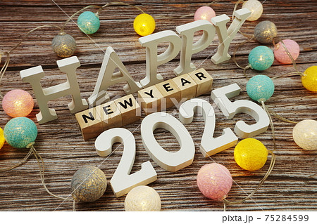 Happy New Year 2025 alphabet letter with LED cotton balls on wooden background 75284599