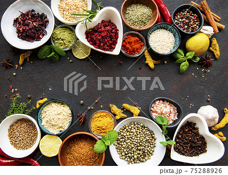 Various spices in a bowls on a black 75288926