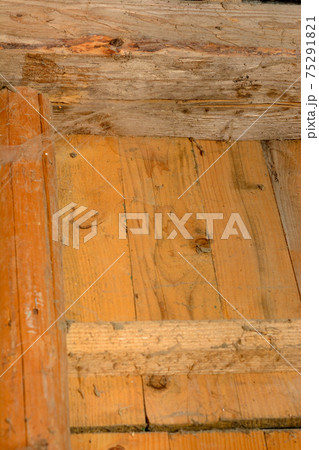 Many spider webs splashed on the wall with spider supports, the wall made of wooden horizontal boards. 75291821