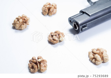 Weapons and brains. Muzzle pistol and brains. Walnut in the form of the brain. Weapons and brains. Muzzle pistol and brains. Walnut in the form of the brain. 75293689