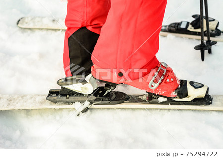 Close-up of a skier ski skier ski boot on a snow-red color 75294722