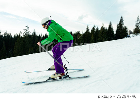 A young man is skiing in the Carpathians on the slopes. A young man is skiing in the Carpathians on the slopes. 75294746