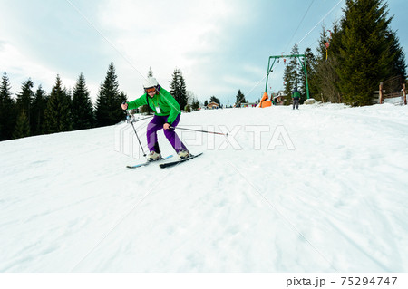 The young guy skis in the Carpathians is not very skillful. 75294747