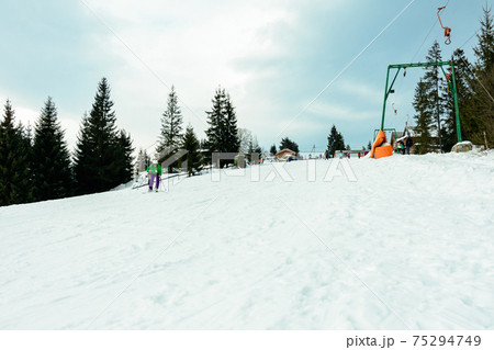 The young guy skis in the Carpathians is not very skillful. The young guy skis in the Carpathians is not very skillful. 75294749
