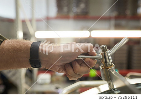 Male Worker Opening Valves at Factory Close Up Male Worker Opening Valves at Factory Close Up 75296111