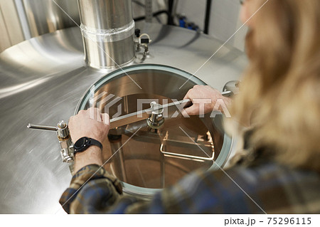 Worker Opening Tanks at Factory Close Up Worker Opening Tanks at Factory Close Up 75296115