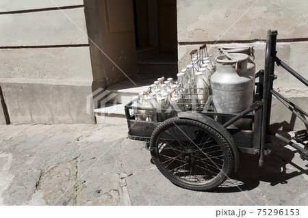 Bottles and aluminum cans of milk for delivery in vintage milkman bicycle Bottles and aluminum cans of milk for delivery in vintage milkman bicycle 75296153