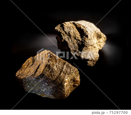 A couple of shiny muscovite mica mineral crystals isolated on black. Found in Ural, Russia. For geology mineralogy magazines or websites, stone collection catalog, Natural Science museum wall chart. 75297700