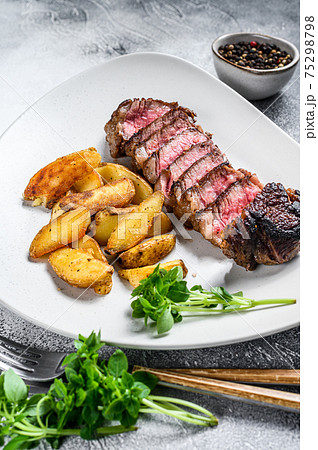 Sliced Grilled rump Beef steak with potato. White background. Top view 75298798
