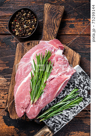 Fresh Raw pork shoulder meat cut with ingredients and spices on kitchen background. Dark wooden background. Top view 75299144
