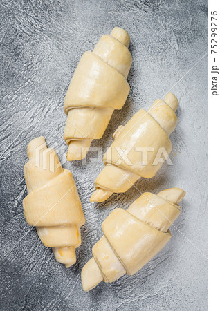 Raw unbaked croissant on kitchen table. White background. Top view Raw unbaked croissant on kitchen table. White background. Top view 75299276