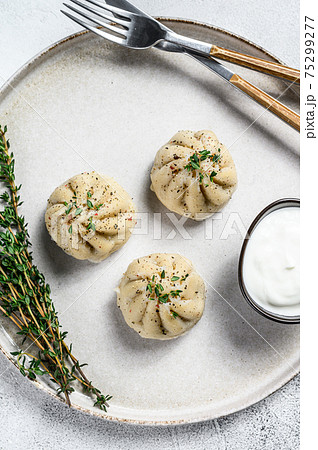 Asian Steamed Dumplings Manti with mince meat on a plate. White background. Top view 75299277