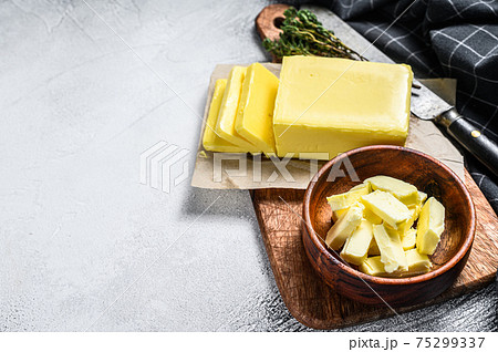Block of fresh Butter, dairy farm products. Gray background.Top view. Copy space 75299337