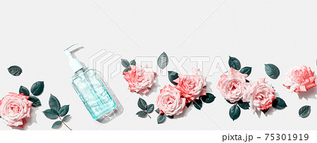 Sanitizer bottle with pink roses overhead view Sanitizer bottle with pink roses overhead view 75301919