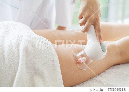 Woman getting LPG massage for skin care in home Woman getting LPG massage for skin care in home 75306318