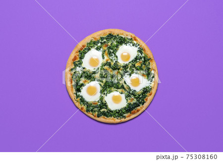 Vegetarian pizza with spinach and eggs isolated on purple color. Pizza, flat lay Vegetarian pizza with spinach and eggs isolated on purple color. Pizza, flat lay 75308160