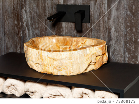 A futuristic washbasin made from a single piece of marble stone. A futuristic washbasin made from a single piece of marble stone. 75308175