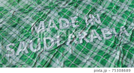 MADE IN SAUDI ARABIA words printed on a cloth, national textile production conceptual 3d rendering MADE IN SAUDI ARABIA words printed on a cloth, national textile production conceptual 3d rendering 75308689