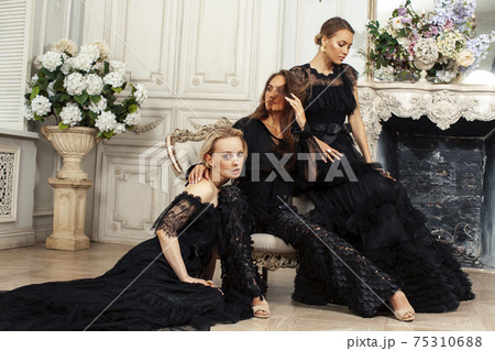 three young pretty lady in black lace fashion style dress posing in rich interior of royal hotel room, luxury lifestyle people concept 75310688