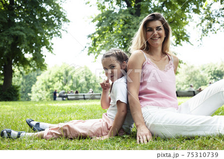 young pretty mother walking with little cute daughter outside in green park, lifestyle poeple concept 75310739