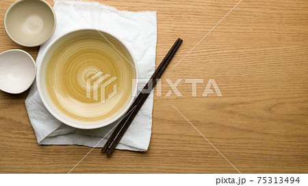 Table Setting Background, mock up ceramic bowls, table cloth and chopsticks on wooden table 75313494